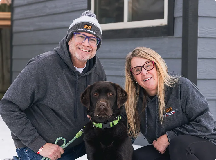 Bryan and Tracy Johnson, owners of Johnson Exteriors, with their dog